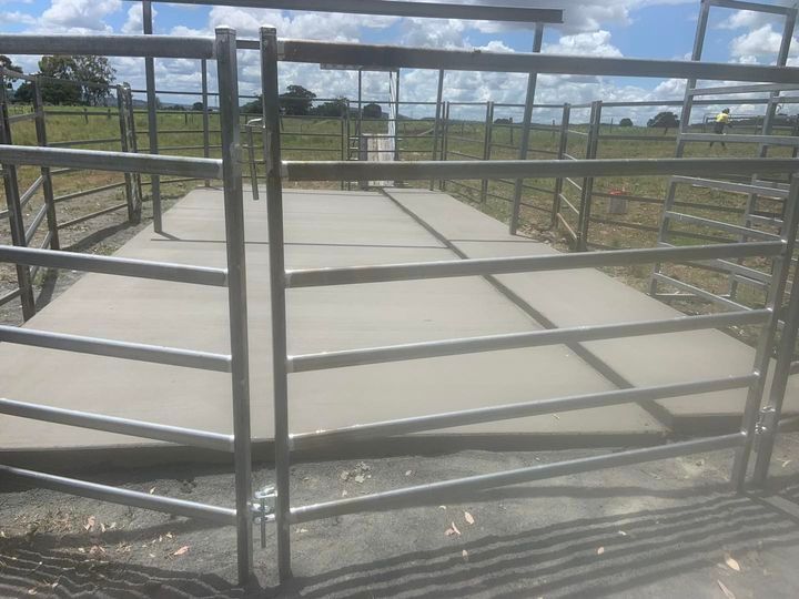 A Metal Fence Surrounds a Concrete Walkway in A Field — Pedro's Concreting in Warwick, QLD