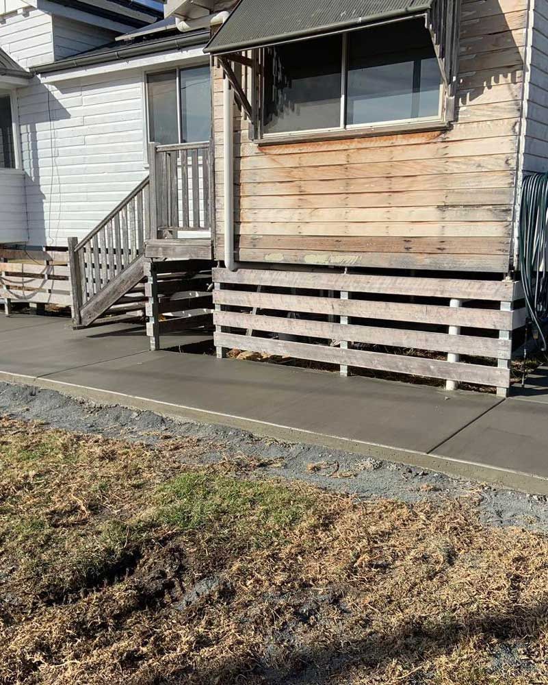 Small Wooden House With Stairs and a Concrete Driveway — Pedro's Concreting in Pittsworth, QLD