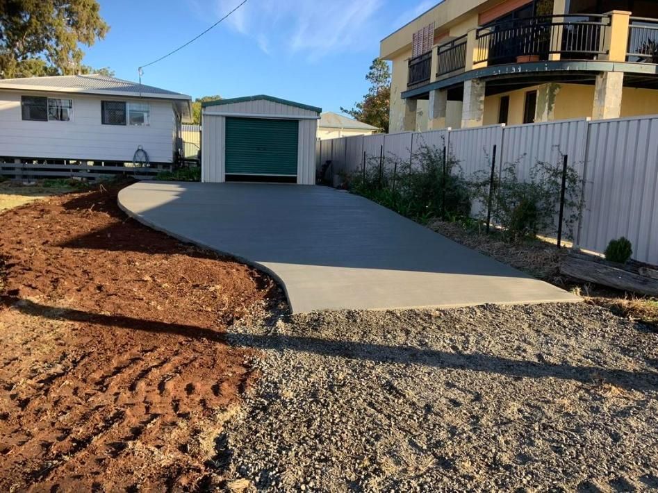 A Concrete Driveway Is Being Built in Front of A House — Pedro's Concreting in Pittsworth, QLD