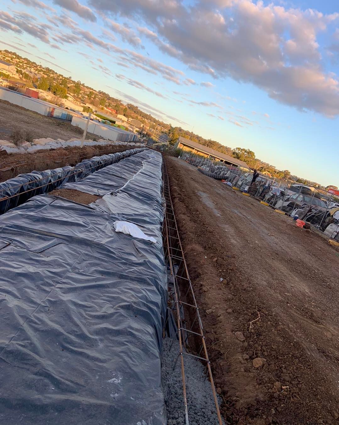 A Large Pile of Dirt is Sitting on Top of a Dirt Road — Pedro's Concreting in Pittsworth, QLD