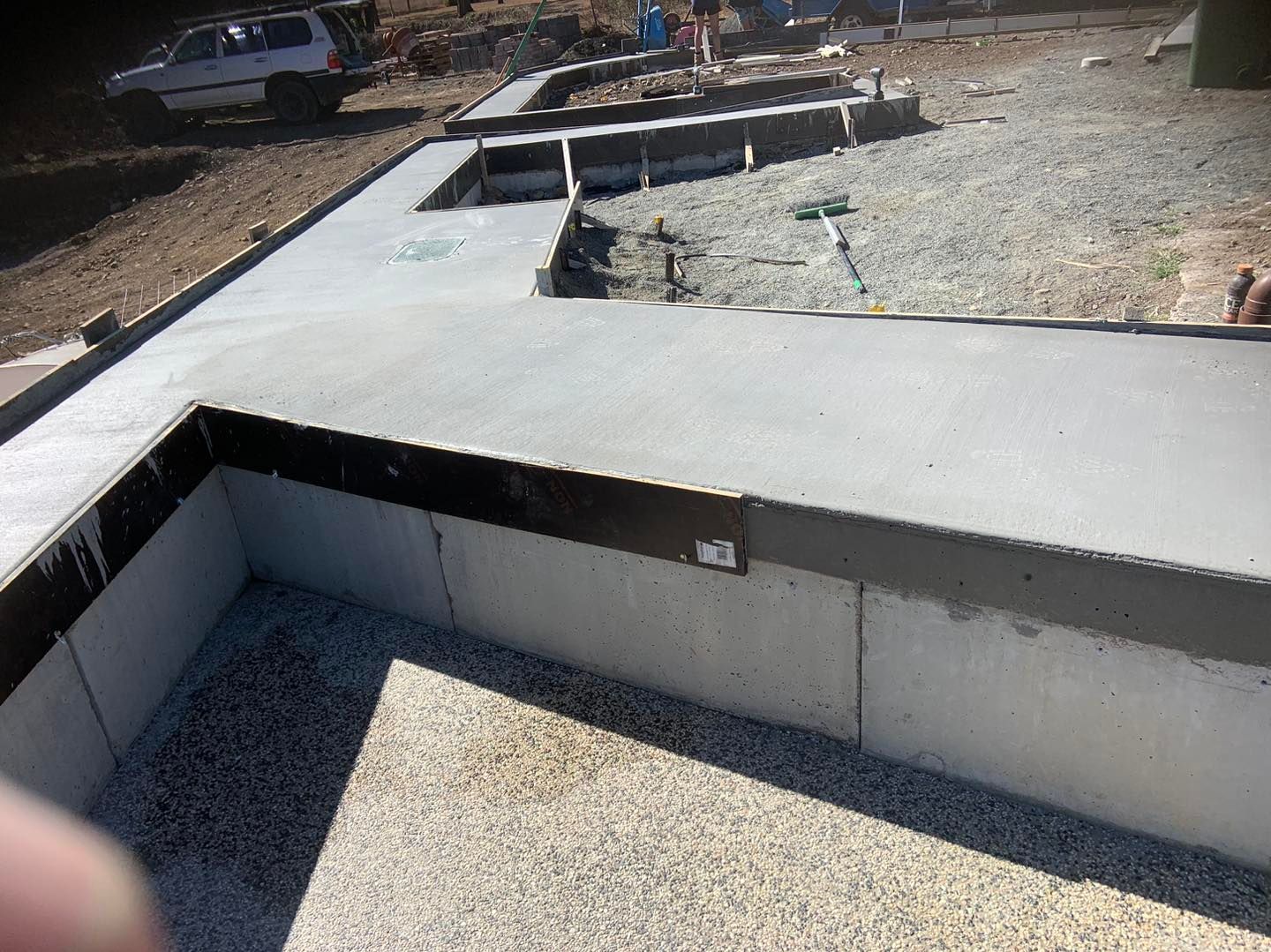 A Person is Standing in Front of a Concrete Wall That is Being Built — Pedro's Concreting in Pittsworth, QLD