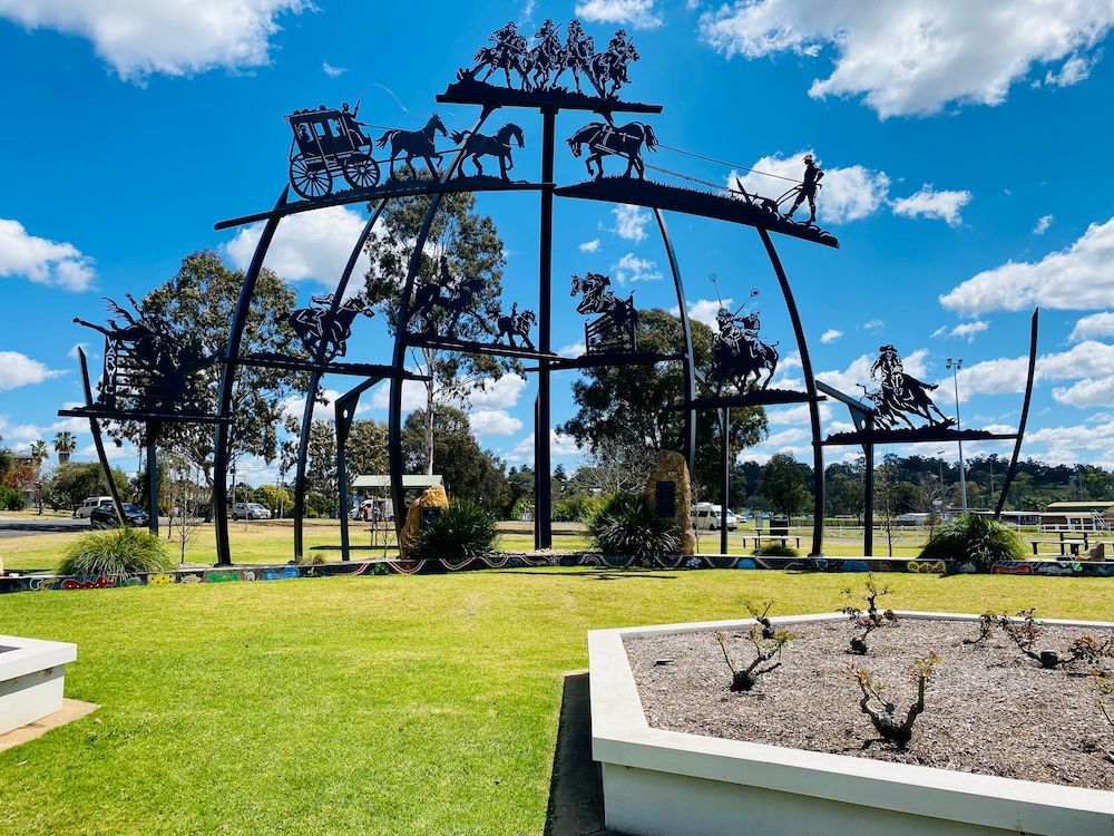 A Large Sculpture of A Horse Drawn Carriage in A Park — Pedro's Concreting in Warwick, QLD