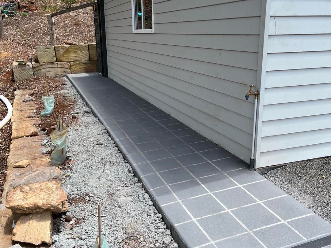 A White House With a Tiled Walkway Leading to It — Pedro's Concreting in Pittsworth, QLD