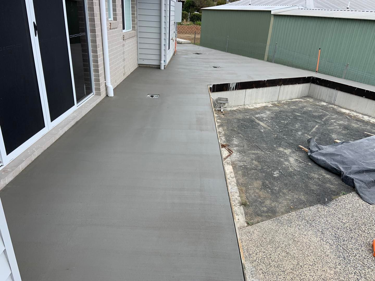 A Concrete Walkway is Being Built in Front of a House — Pedro's Concreting in Pittsworth, QLD