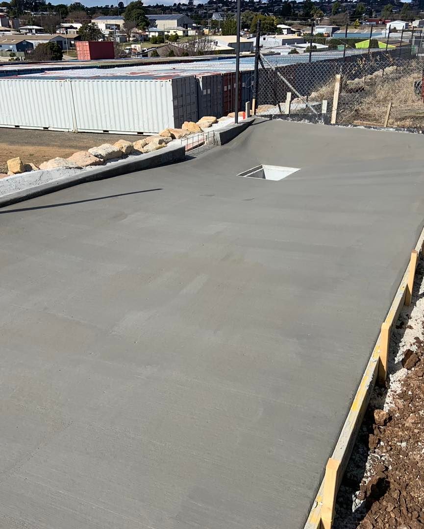 A Brick House with A Concrete Patio in Front of It — Pedro's Concreting in Pittsworth, QLD