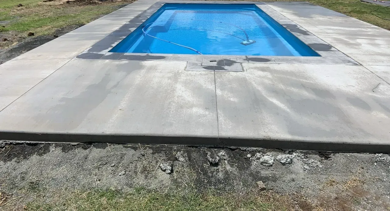 A Large Swimming Pool Is Sitting on Top of A Concrete Patio — Pedro's Concreting in Warwick, QLD