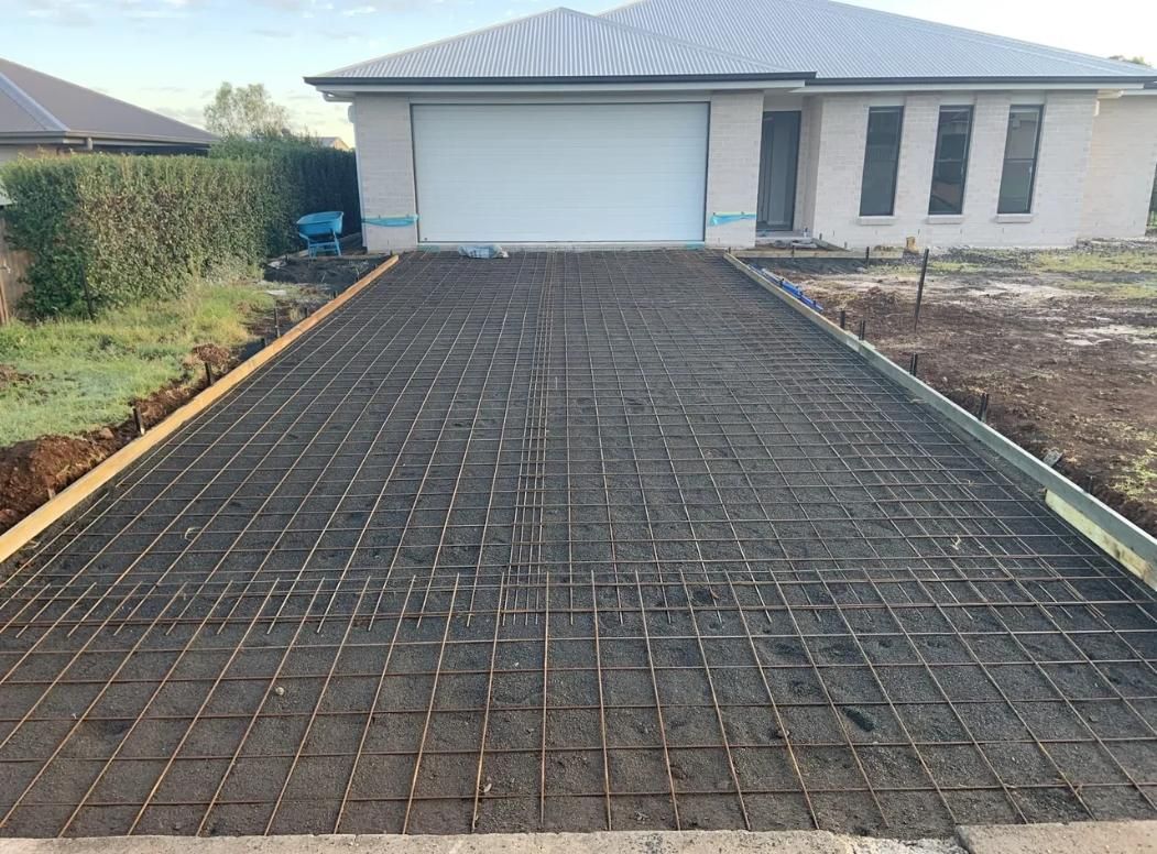 A Driveway Is Being Built in Front of A House — Pedro's Concreting in Millmerran, QLD