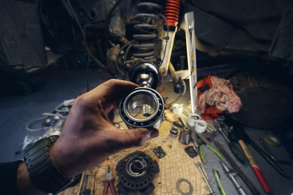 Person is Holding a Bearing in Their Hand in a Garage — Kirra Mechanical in Coolangatta, QLD