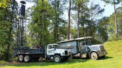 Well Repair — Two Trucks Drilling an Outdoor Well in Bogue Chitto, MS
