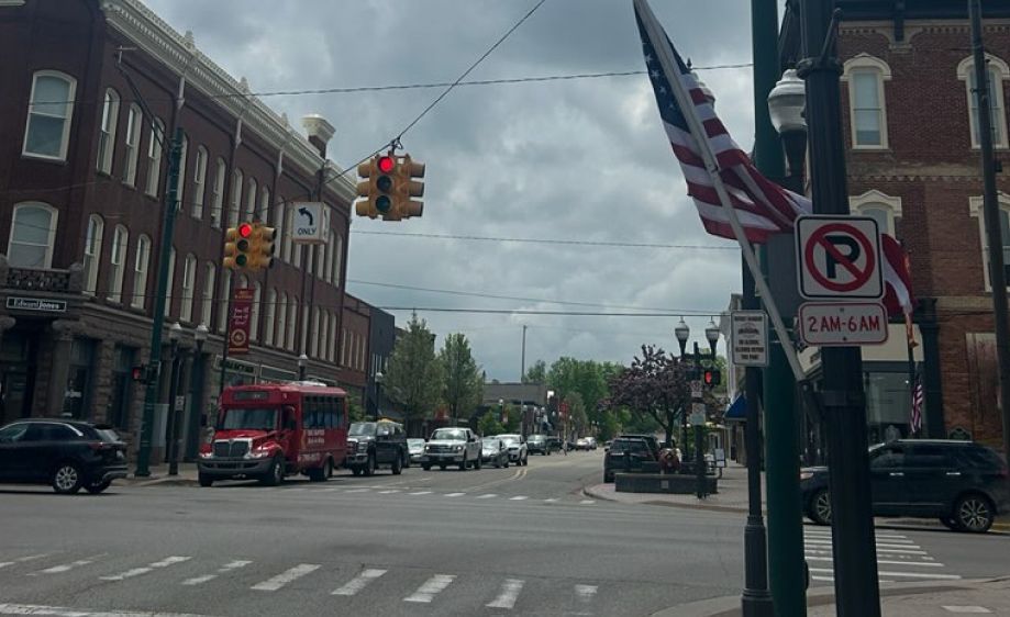 A street with a no parking sign in the foreground in Big Rapids, Michigan.