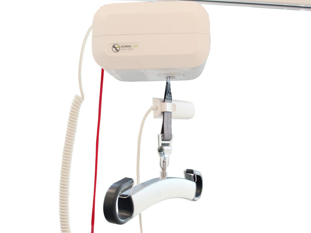 A white ceiling lift with a red cord attached to it.