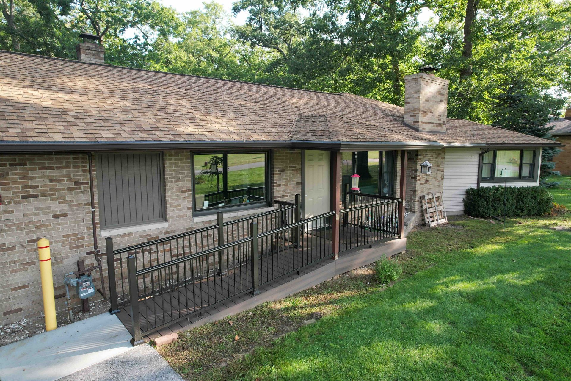 A brick house with a front wheelchair ramp.