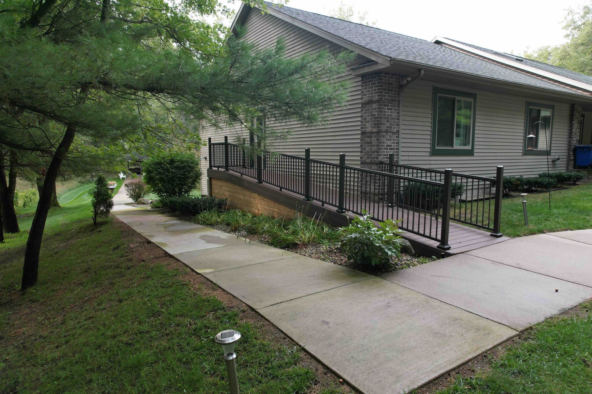 a house with a ramp and a walkway leading to it.