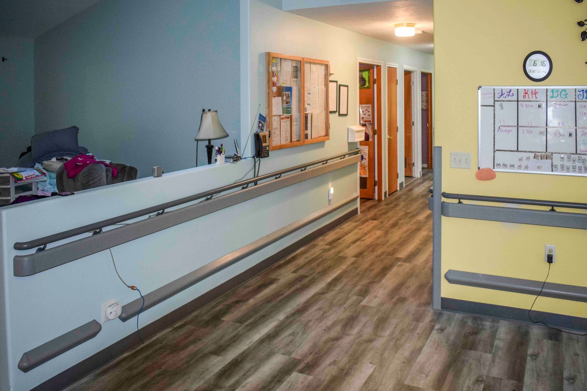 A long hallway in a group home with handrails and grab bars.
