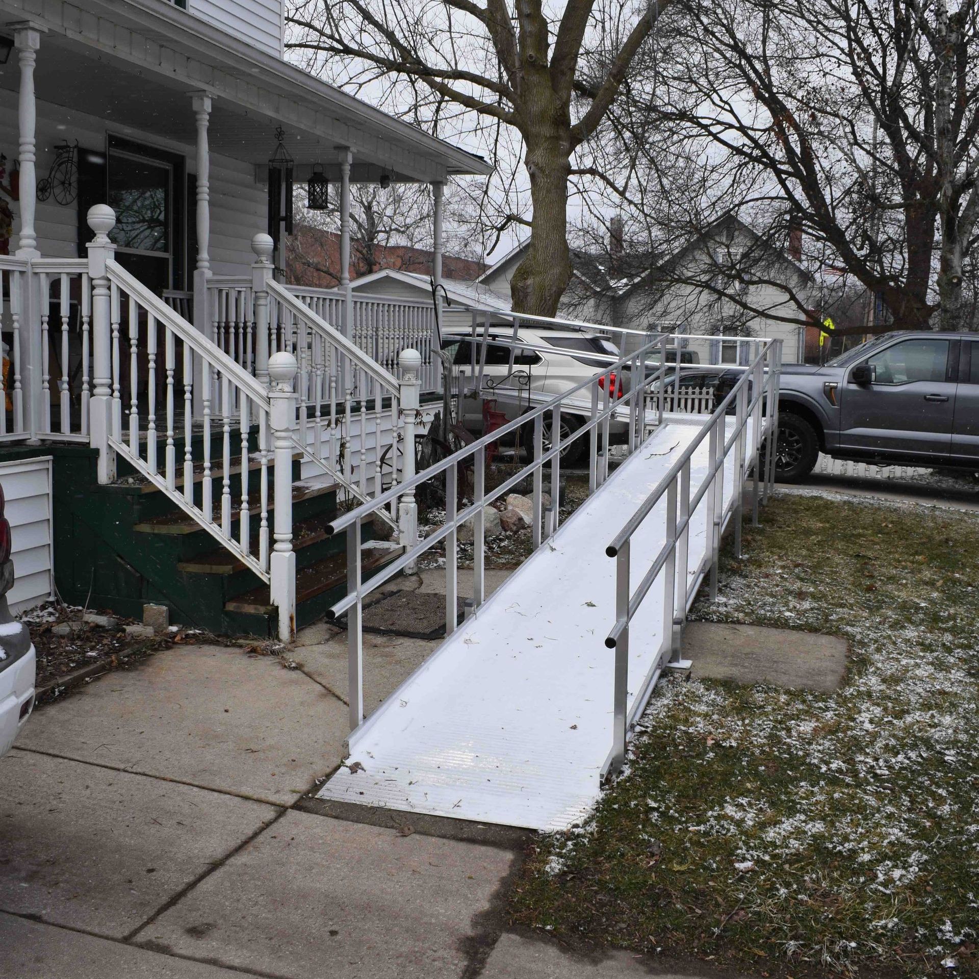an aluminum ramp rental leading to the front of a house.