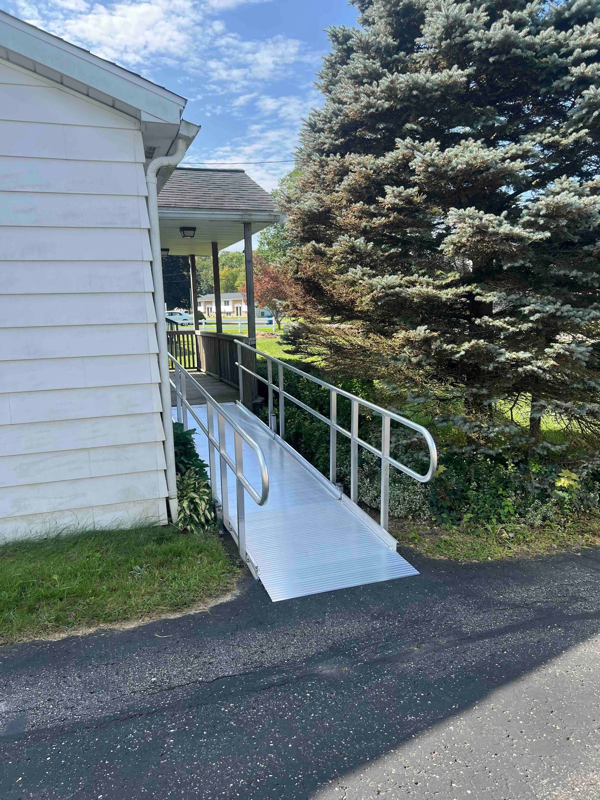 A white house with a ramp leading to it.