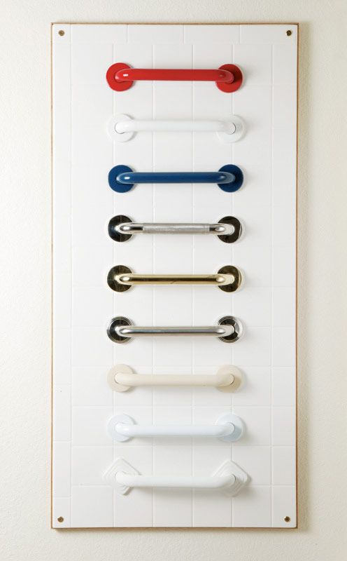 a row of different colored handles on a white board.