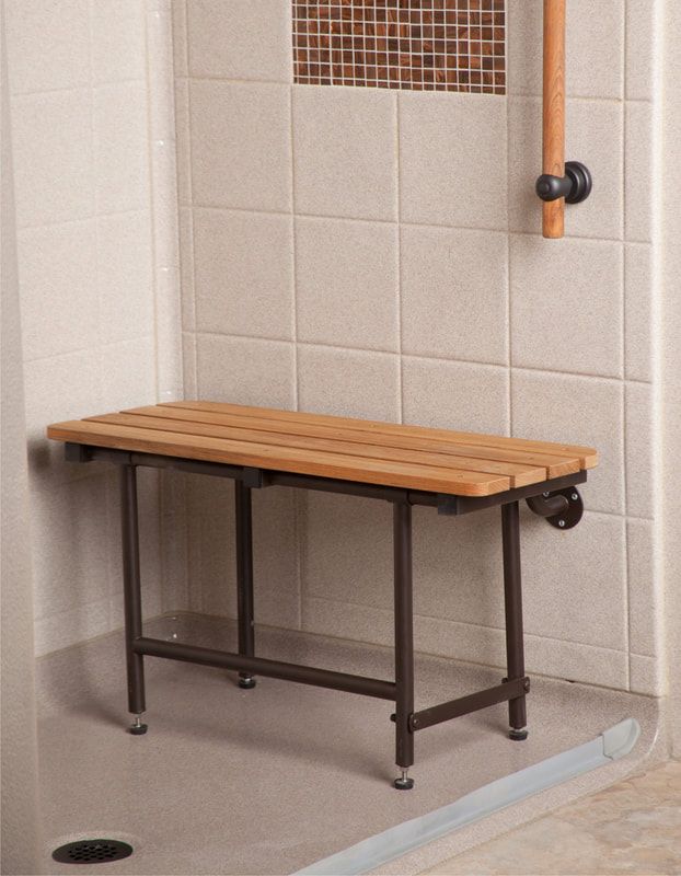 a wooden bench sits in the corner of a shower stall.