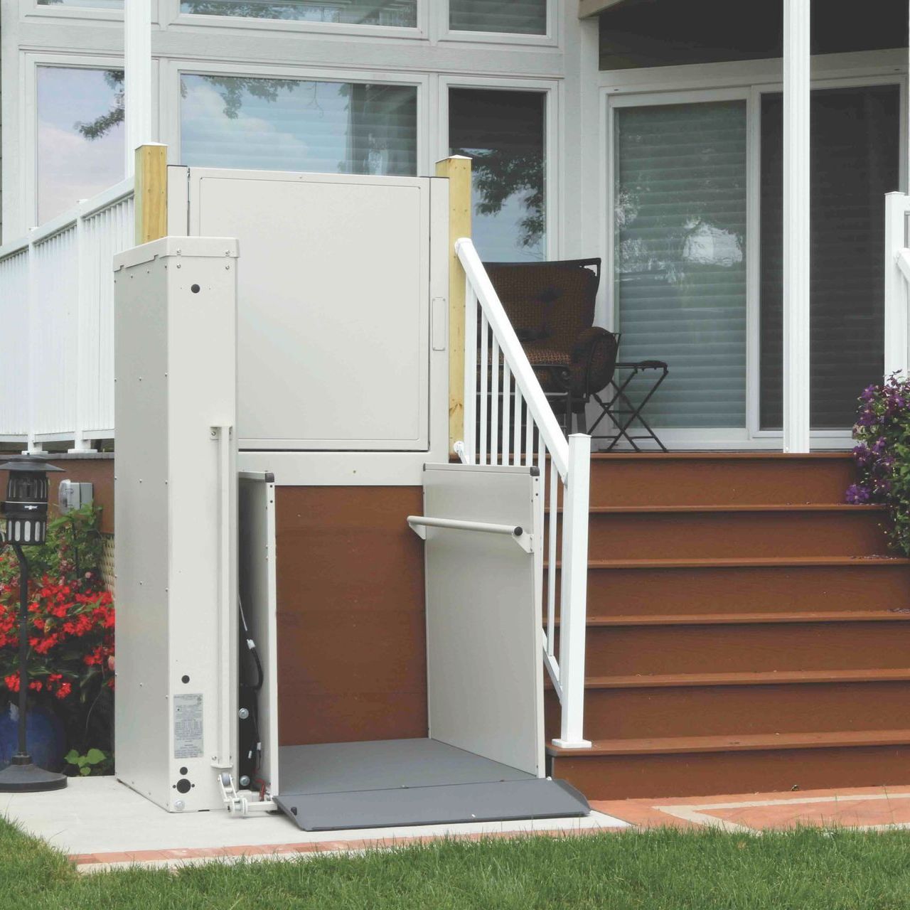 A stair lift is attached to the side of a house