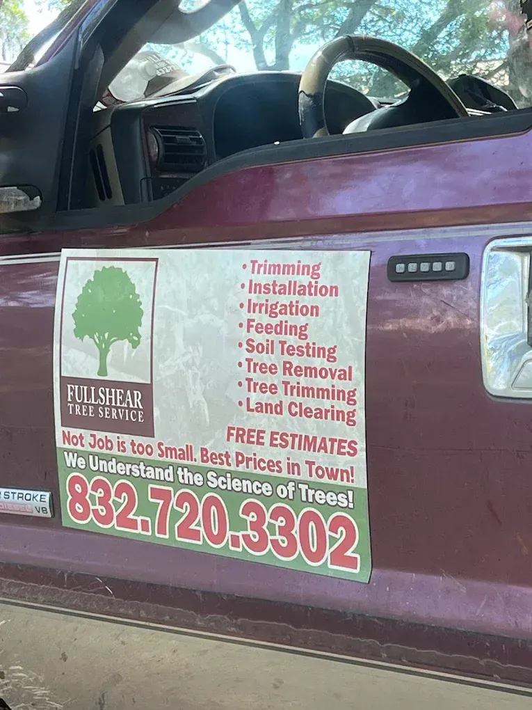 A truck door with a Fullshear Tree Service advertisement listing services, a phone number, and a green tree logo.
