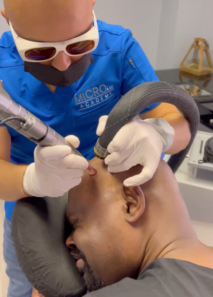 A man is getting a laser treatment on his scalp.