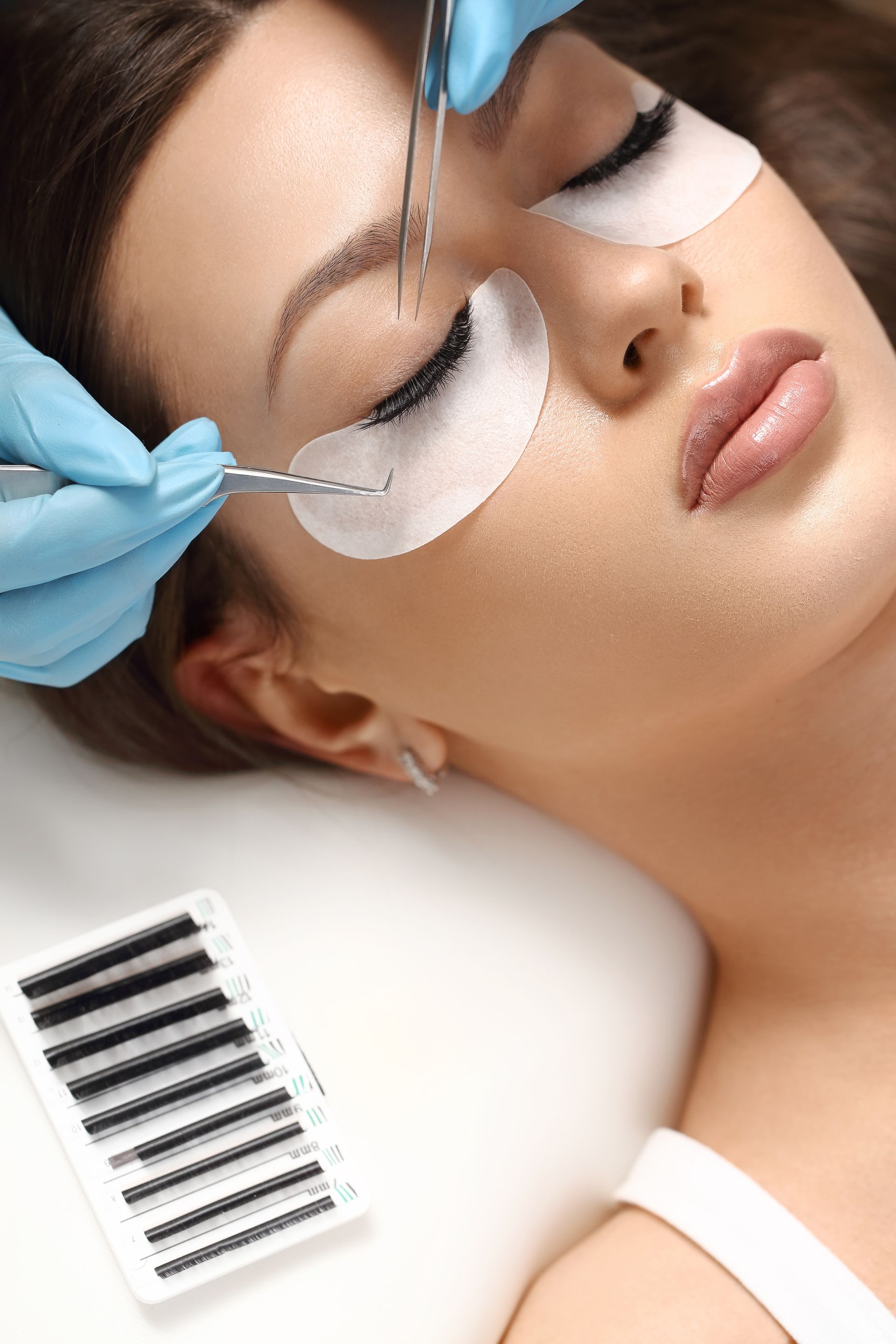 A woman is getting her eyelashes done at a beauty salon.