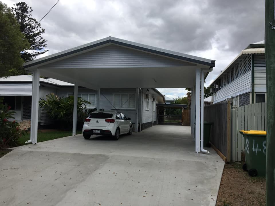 A Car Is Parked Under A Carport In Front Of A House — Darryl Tickle Building Pty Ltd In Alice River, QLD
