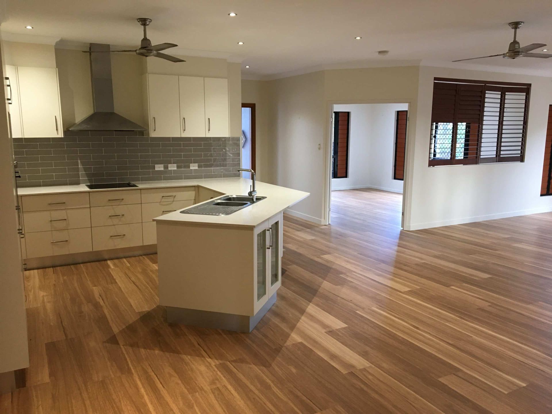 White Kitchen With Wooden Flouring  — Darryl Tickle Building Pty Ltd In Alice River, QLD