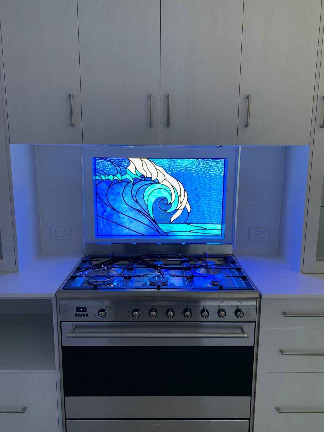 A Stove Top With a Glass Splash Back Design— Darryl Tickle Building Pty Ltd In Alice River, QLD