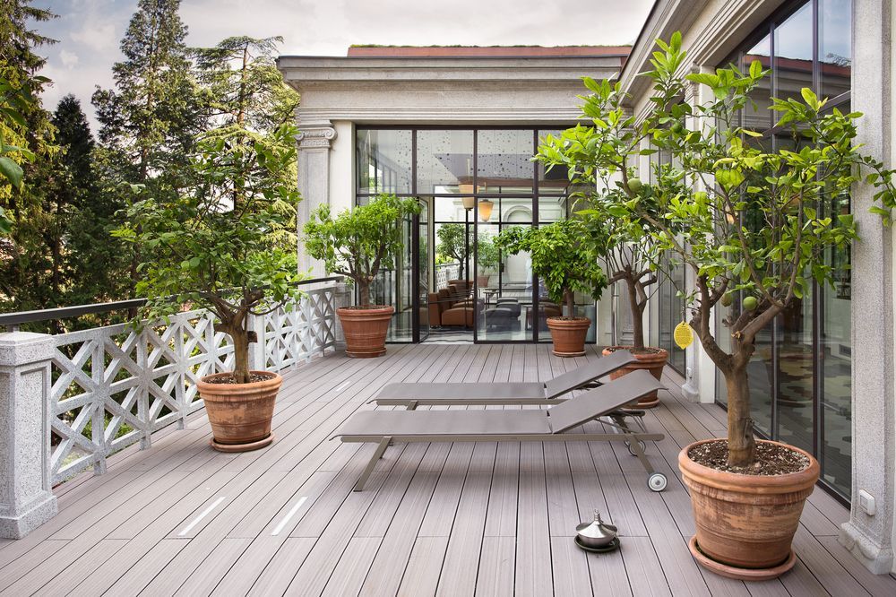 A Balcony With A Lot Of Potted Plants On It — Country To Coast Building Contractors In Landsborough, QLD