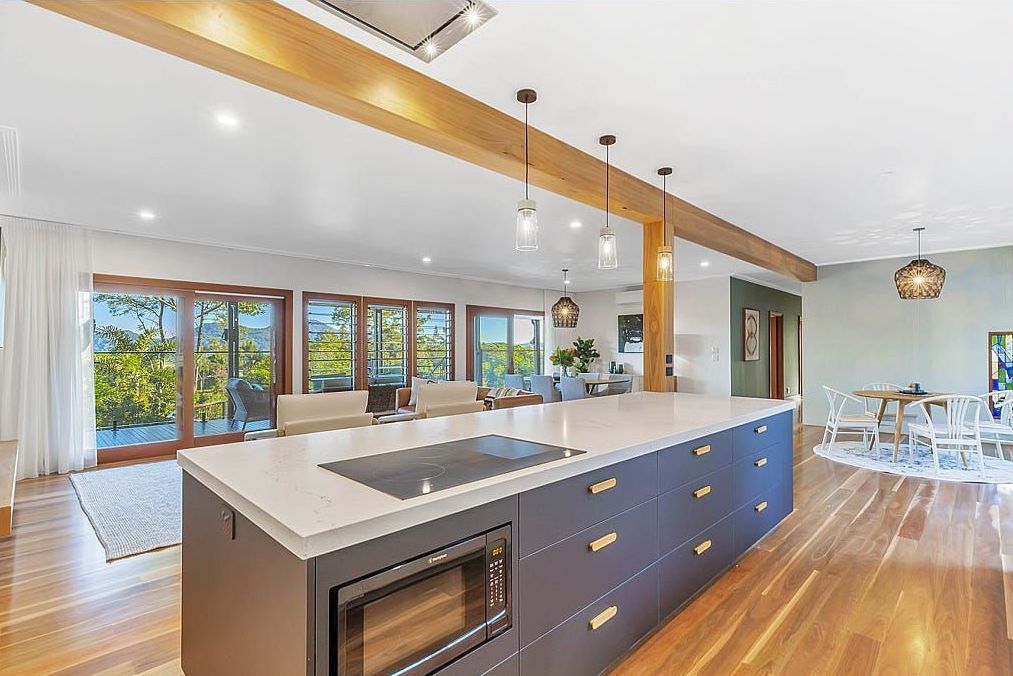 A Kitchen With A Large Island In The Middle Of The Room — Country To Coast Building Contractors In Landsborough, QLD