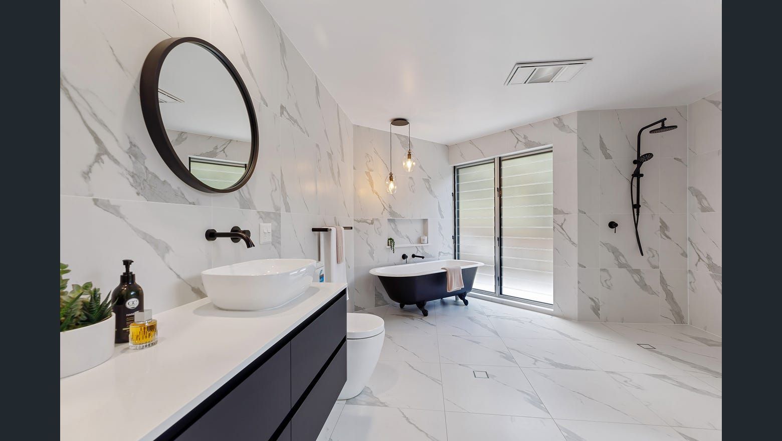 A Bathroom With A Tub, Sink, Mirror And Toilet — Country To Coast Building Contractors In Noosa, QLD
