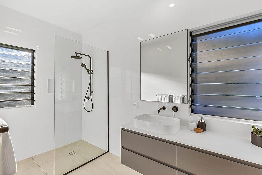 A Bathroom With A Walk In Shower And Sink — Country To Coast Building Contractors In Landsborough, QLD