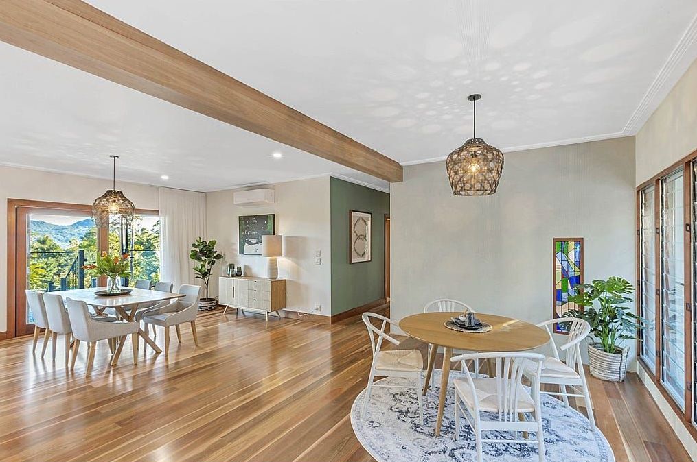 A Large Dining Room With A Round Table And Chairs — Country To Coast Building Contractors In Landsborough, QLD