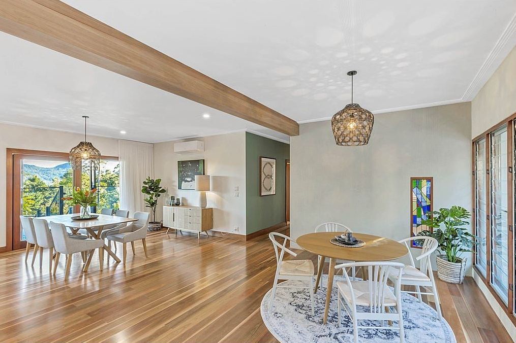 A Large Dining Room With A Round Table And Chairs — Country To Coast Building Contractors In Landsborough, QLD