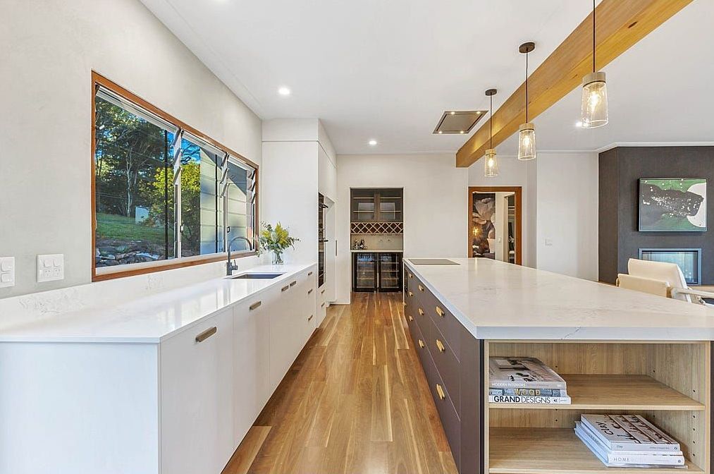 A Kitchen With A Large Island In The Middle Of It — Country To Coast Building Contractors In Landsborough, QLD
