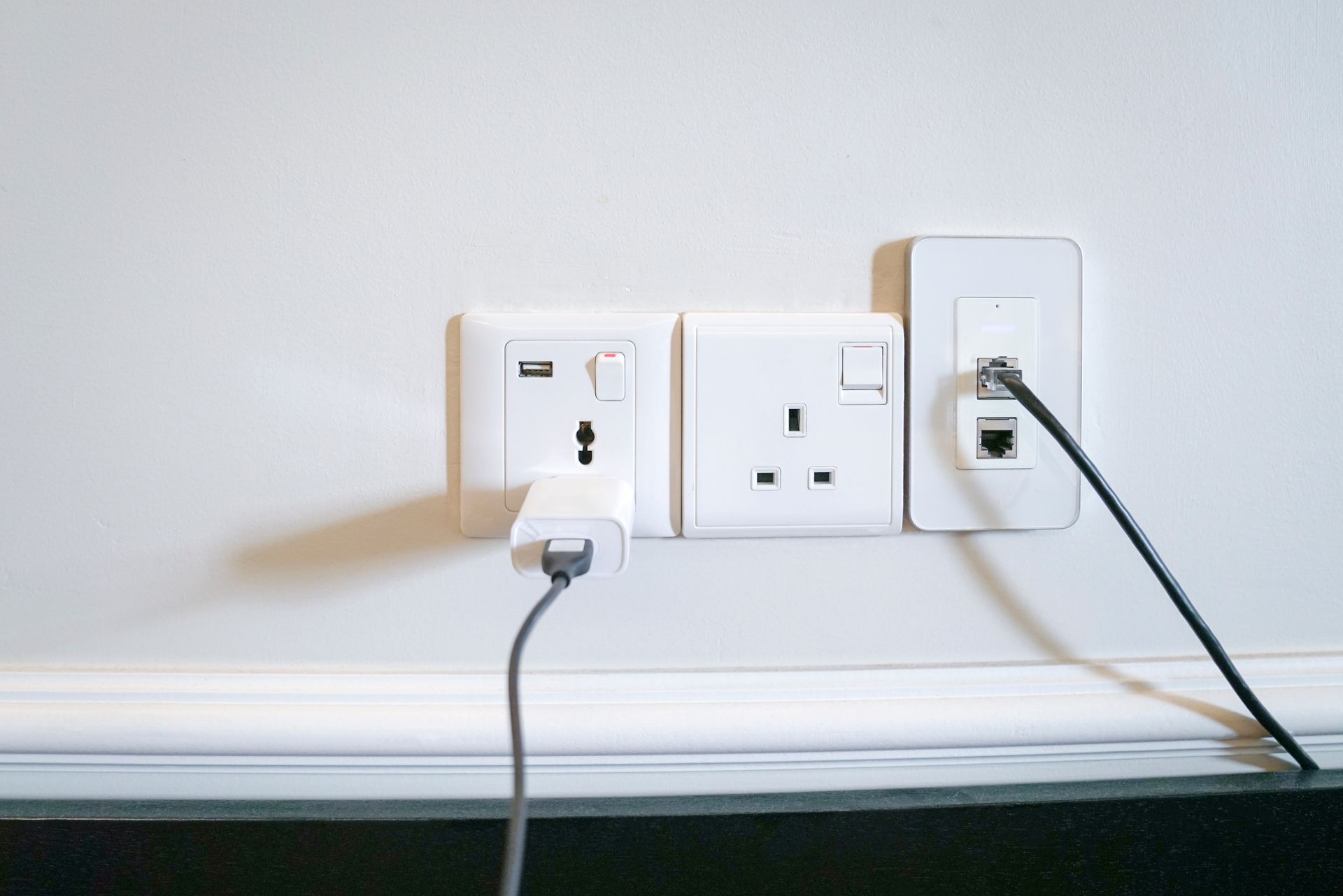 Electrical cord securely plugged into a wall outlet.