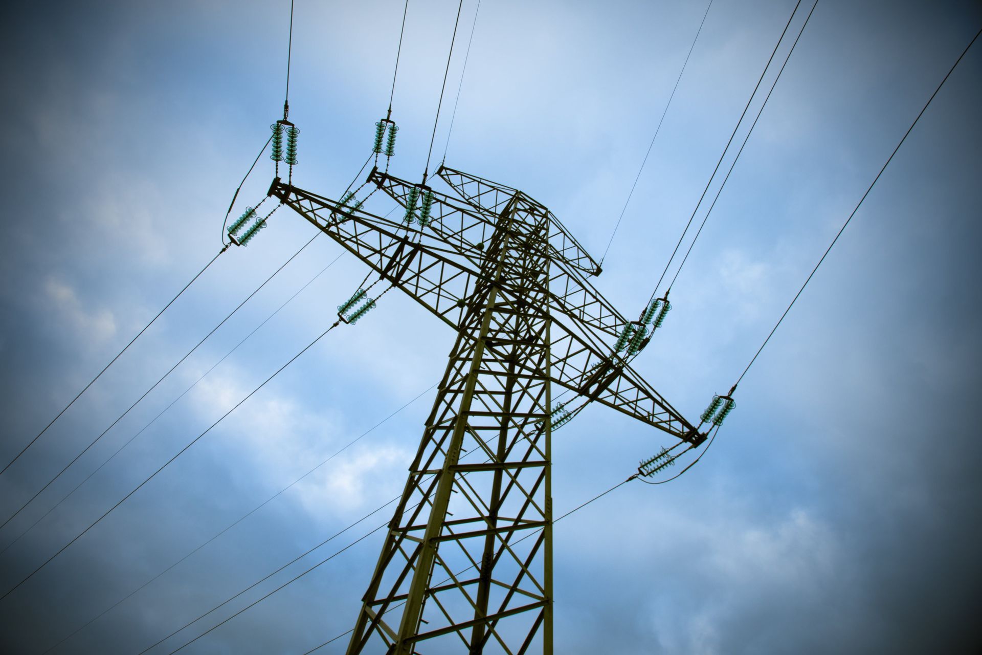 A white electric tower against a clear sky.