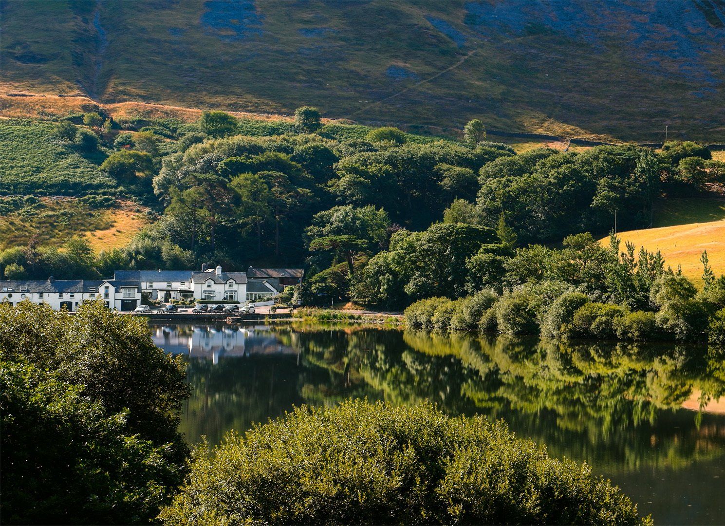 The view of the Ty'n y Cornel Hotel from across the Talyllyn Lake.