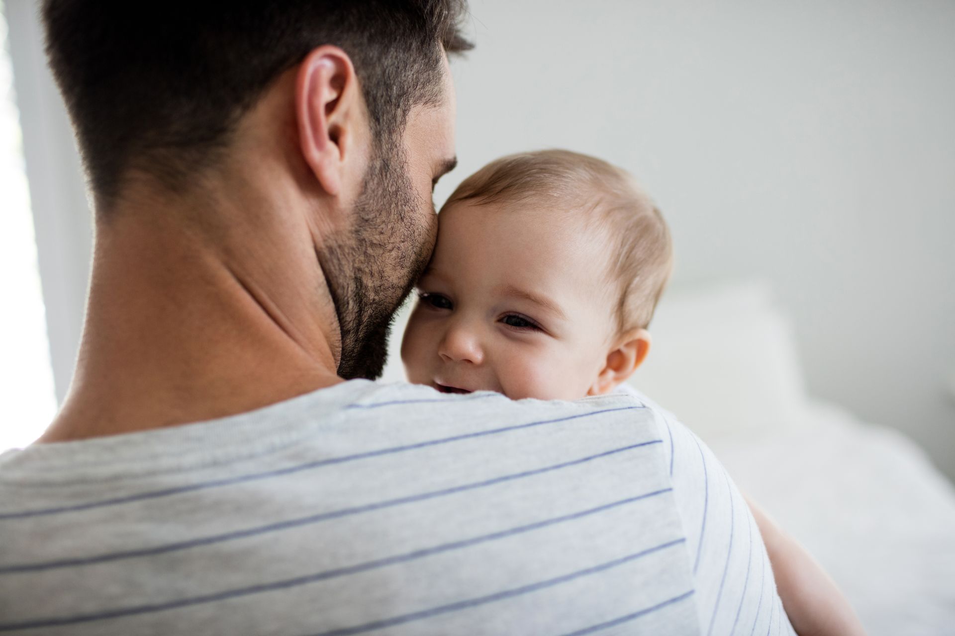 Young dad holding new baby