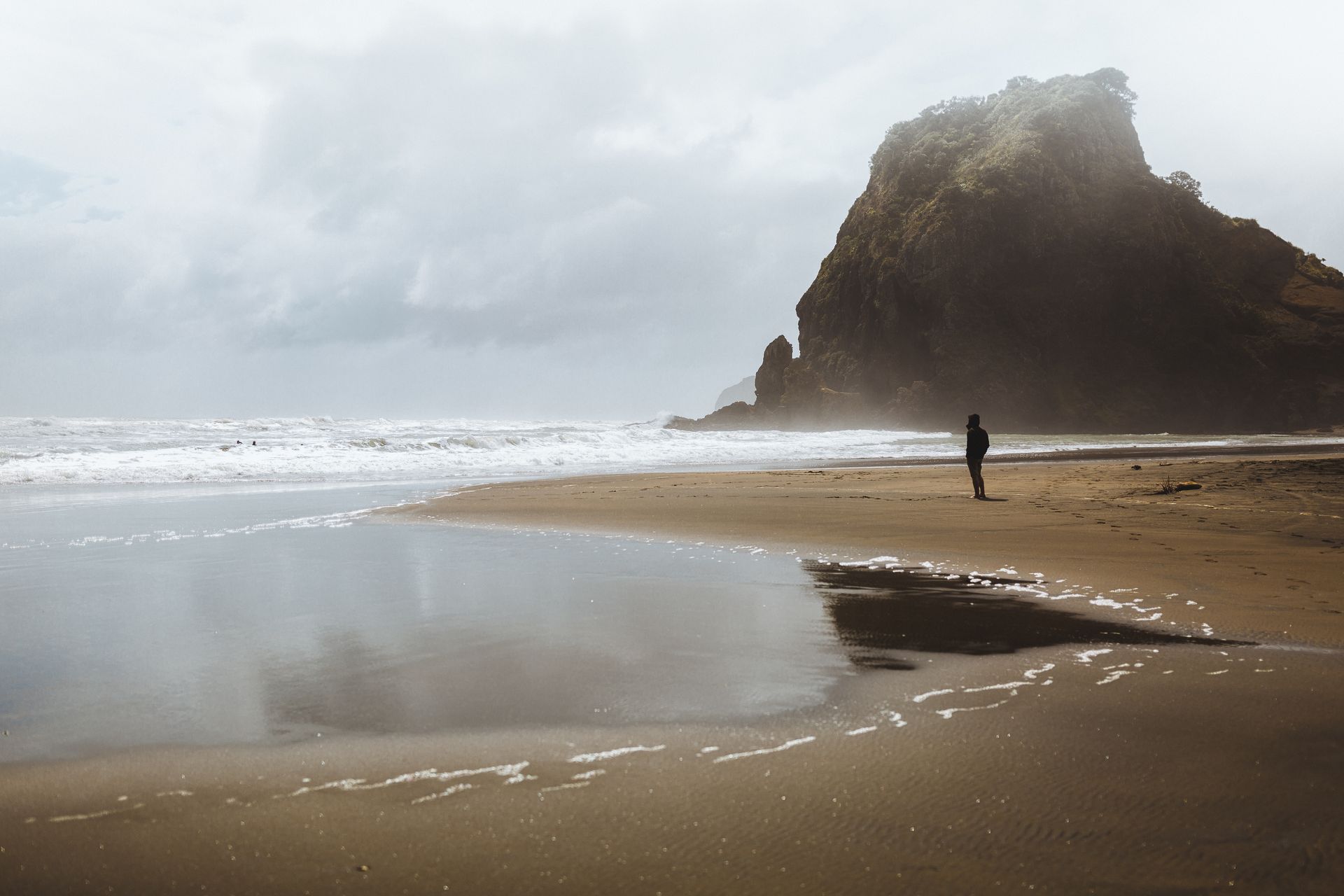 Man pondering life issues along edge of ocean