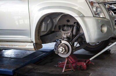 Changing wheel on a car — Brake Services in Denton, Texas