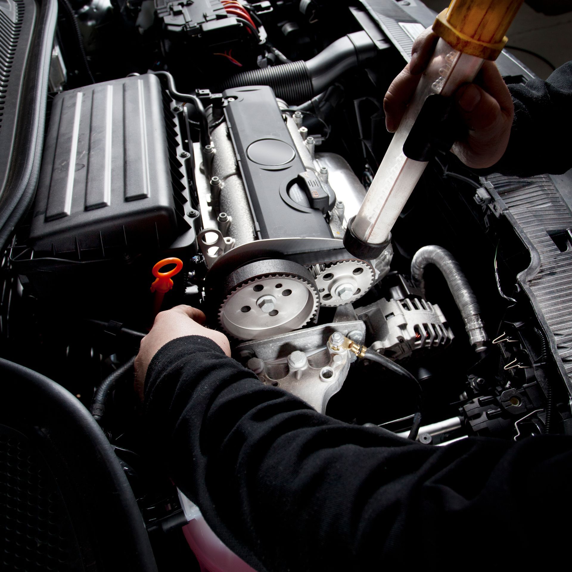 Mechanic is checking the timing belt of a modern car — Engine Diagnostics in Denton, Texas