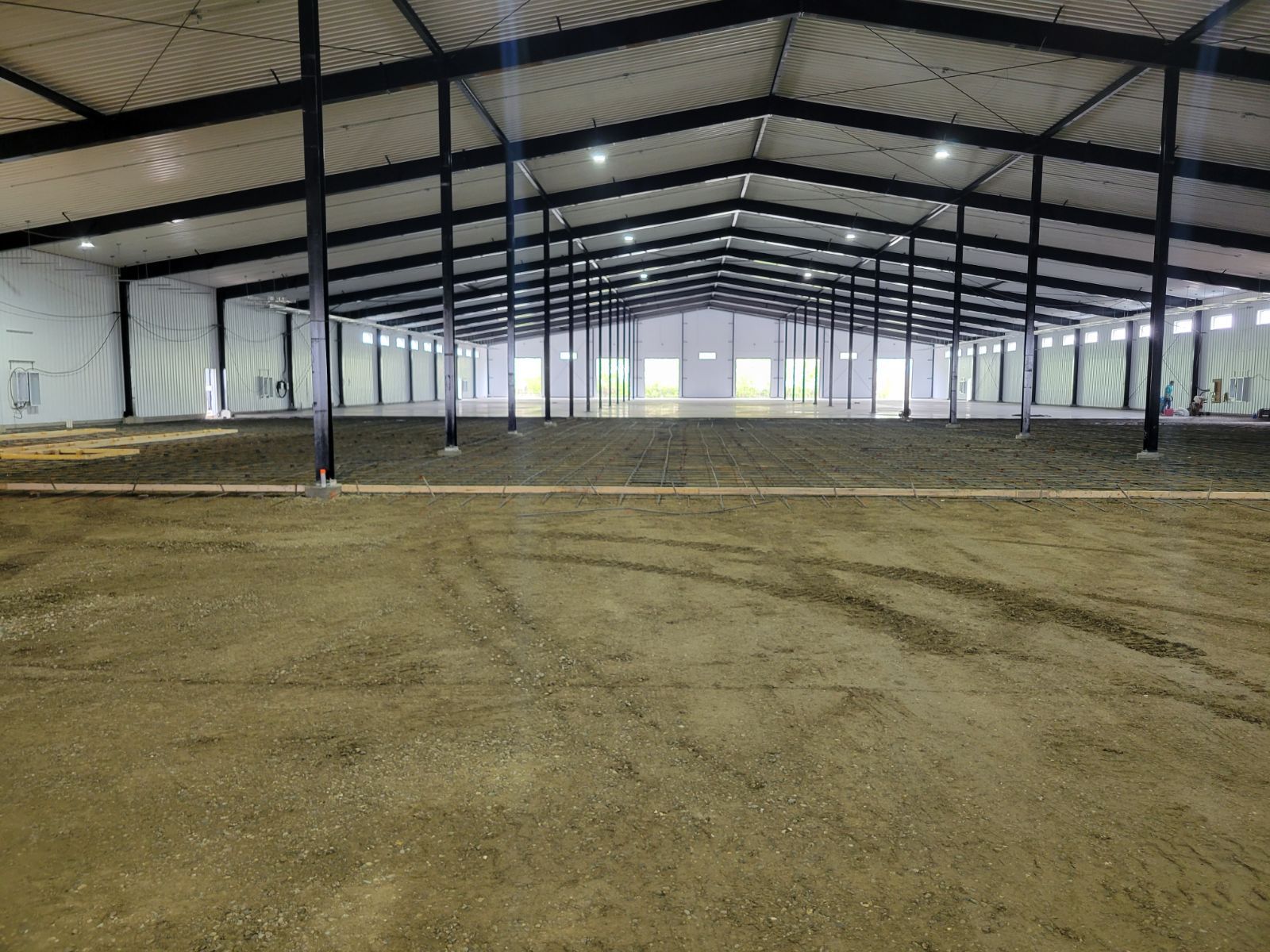 An empty warehouse with a lot of dirt in it