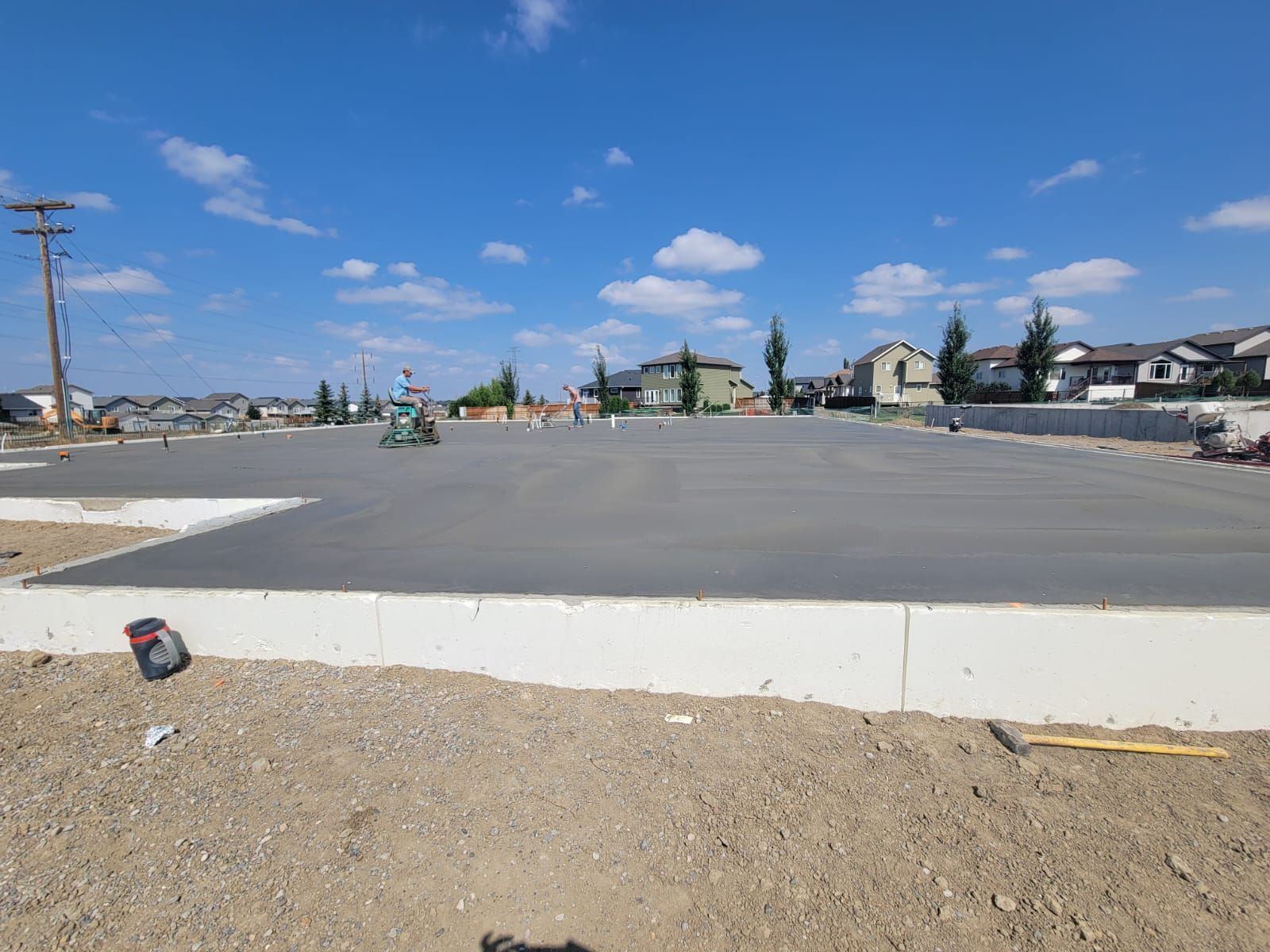 A large concrete slab is sitting in the middle of a dirt field.