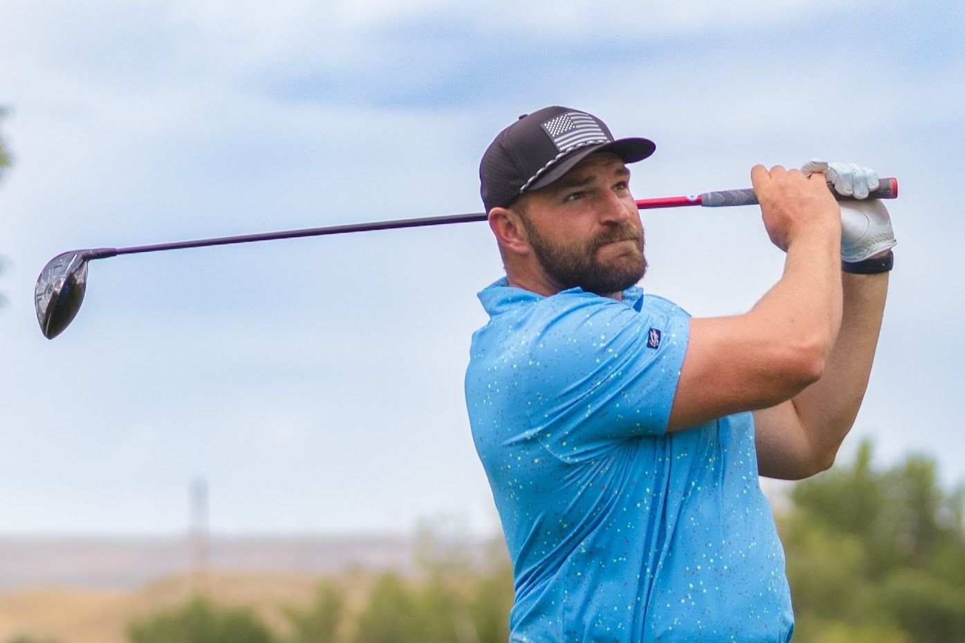 Golfer swinging club at Casper Country Club