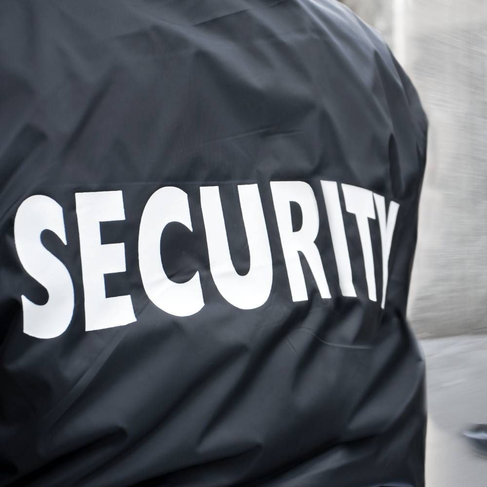 A black jacket with the word security on the back