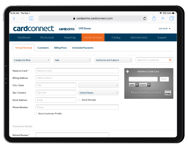 a laptop and a tablet are sitting on a wooden table .