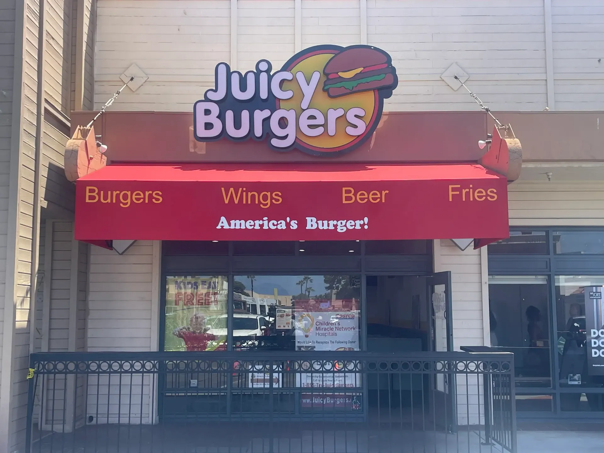 A living room with a stone fireplace and a flat screen tv