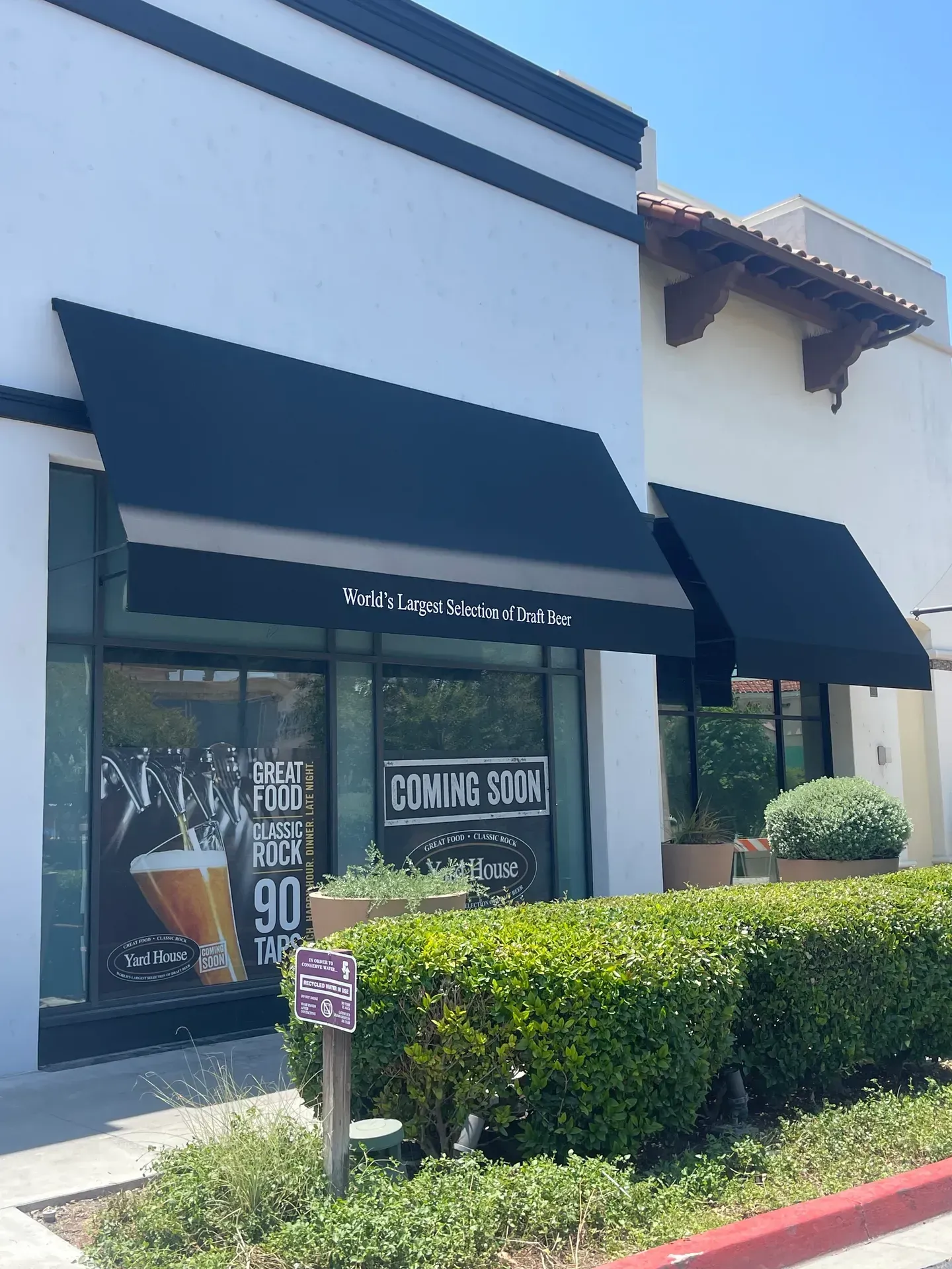 A house with a gutter on the side of it and a sunset in the background.